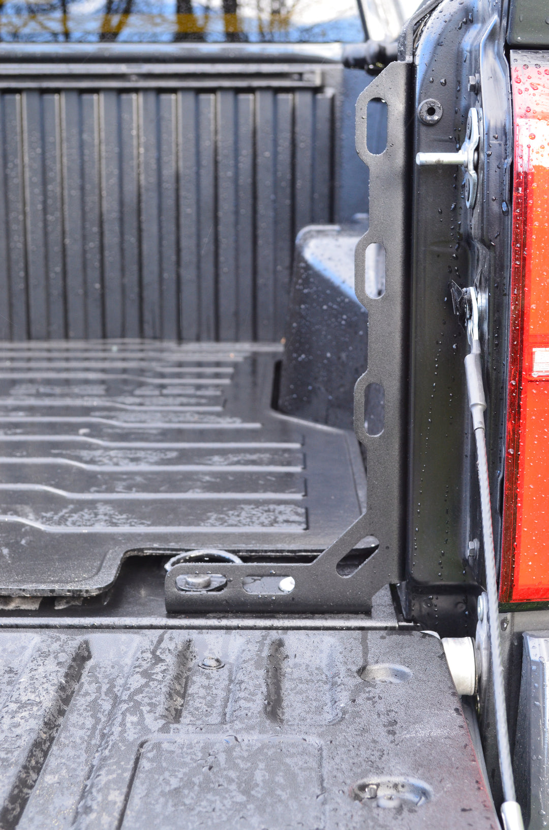 Close-up view of the BPF 2024-2025 Toyota Tacoma Bed Stiffeners installed on a black truck bed, showing durable construction and OEM fitment with tailgate in lowered position.