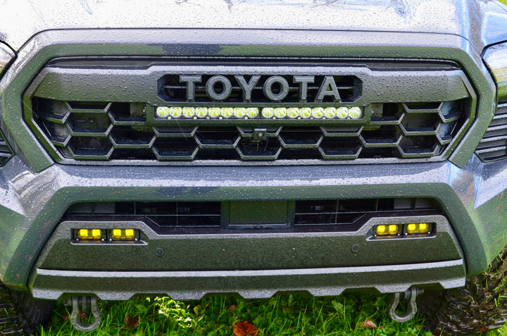 Close-up of a black 2024 Trailhunter Grille with BPF letters installed on a rugged truck front, featuring a honeycomb grill mesh and integrated LED light bar for enhanced off-road visibility.