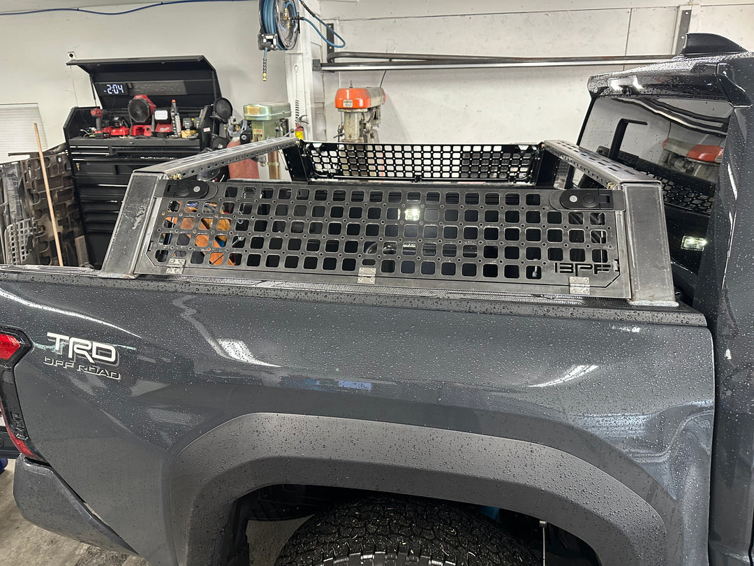 05-26 Tacoma Bed Rack fits 2nd,3rd and 4th gen Tacomas installed on a gray Toyota Tacoma TRD Pro with a sturdy black metal mesh design and durable construction.