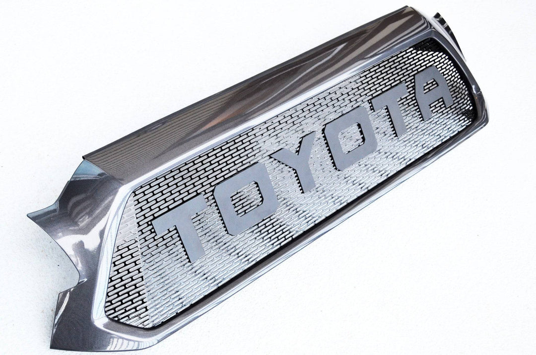 BPF Completed 2012-2015 Toyota Tacoma Grill with a sleek black finish and bold TOYOTA lettering, designed for CNC fabricated precision and OEM fitment.
