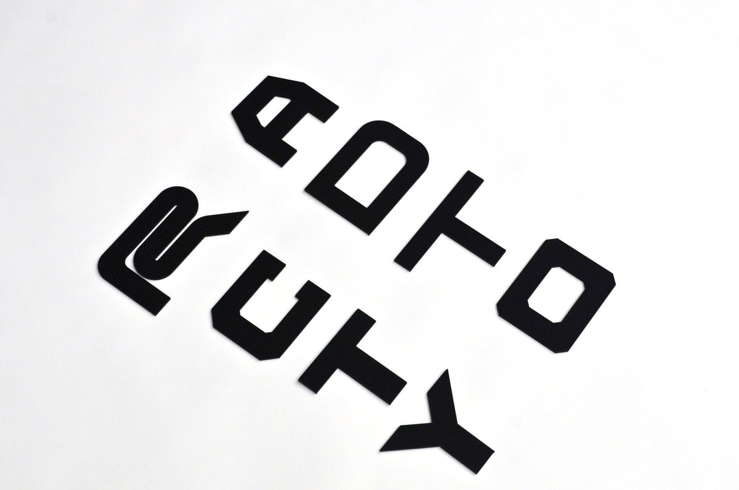 BPF Grill Lettering consisting of bold, stylized black metal letters designed for custom automotive grills, showcasing a modern and durable finish.