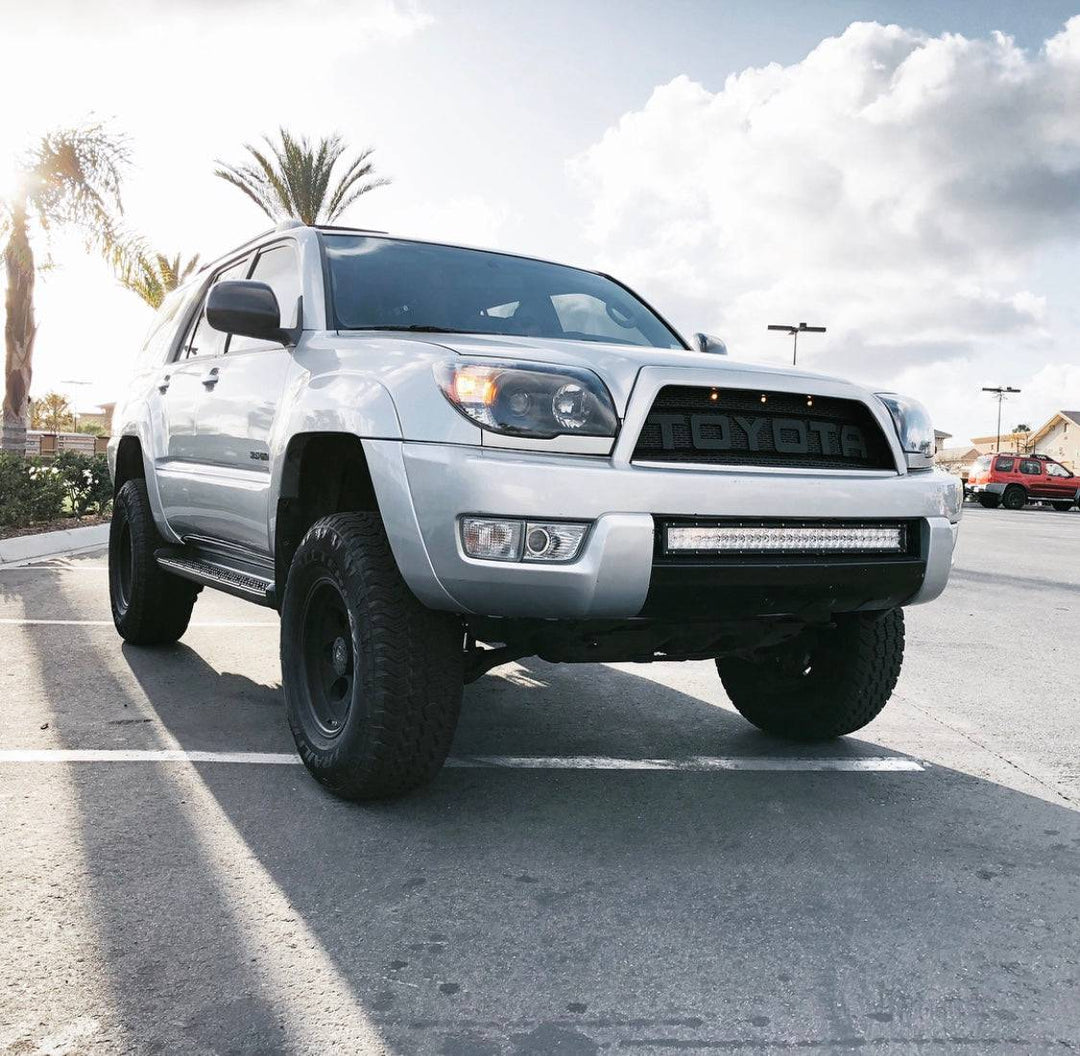 Silver Toyota 4Runner with a BPF 03-09 Toyota 4runner Grill installed, featuring a durable, black mesh design for enhanced front-end protection and off-road style.