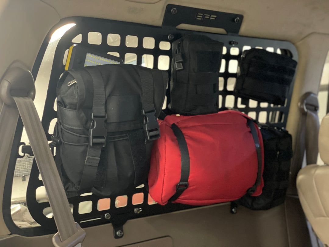 BPF 1990-1997 Toyota Land Cruiser Storage Panels installed with organized black and red gear bags mounted on the vehicle interior, designed for durable, CNC fabricated overlanding storage solutions.