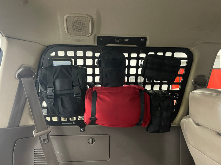 BPF 1990-1997 Toyota Land Cruiser Storage Panels installed inside vehicle with multiple black and red storage pouches attached, showcasing organized overlanding gear and tool-free install.