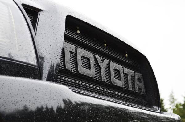 Close-up of a black grill mesh with the large word TOYOTA and installed BPF Grill LED&